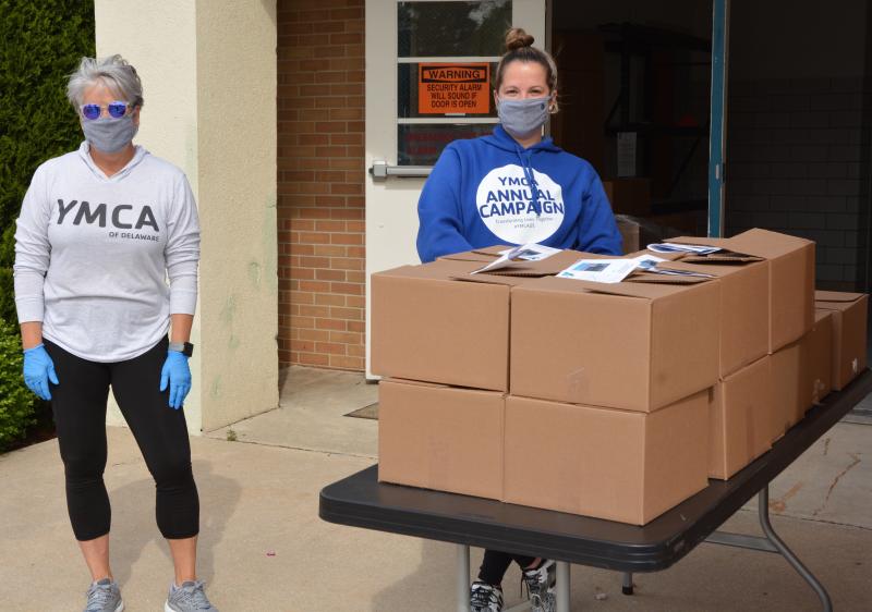Sussex Family YMCA employees Lori Waldee-Warden, left, and Ashley Savage helped distribute 90 prepackaged boxes.